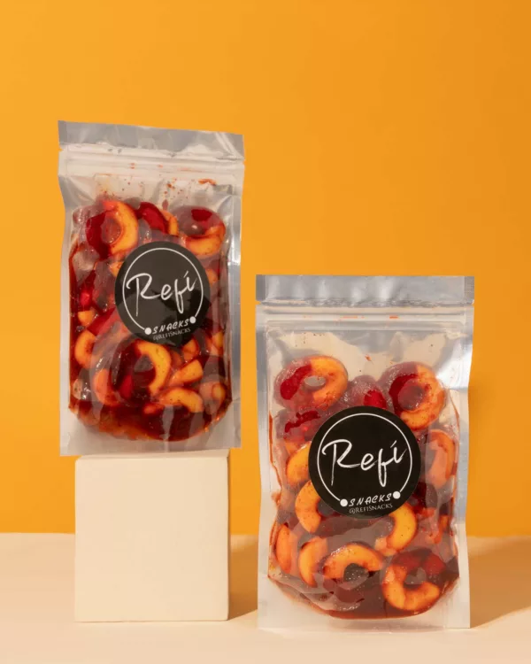 Two packs of Peach rings coated in RefiSnacks chamoy paste