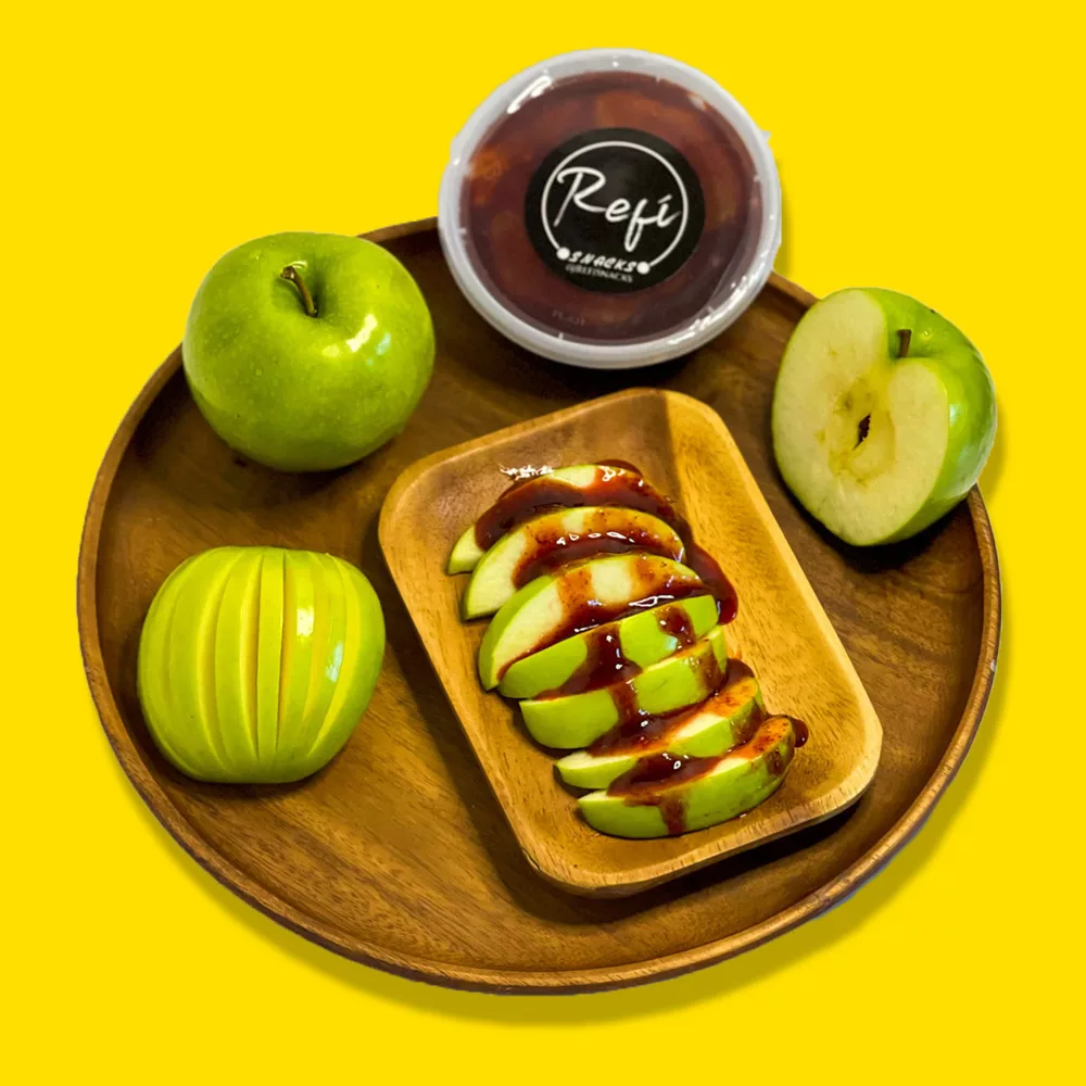 wood serving tray with sliced apples with the RefiSnacks paste on them